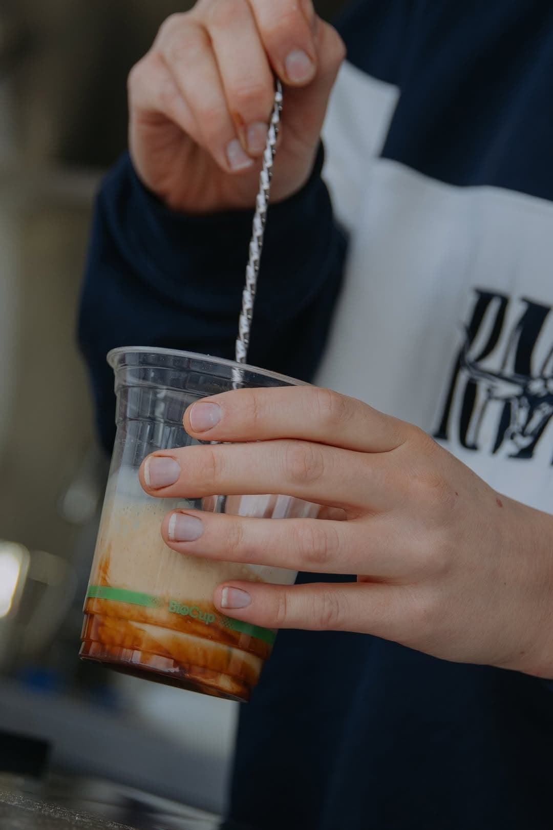An iced coffee being stirred at the van
