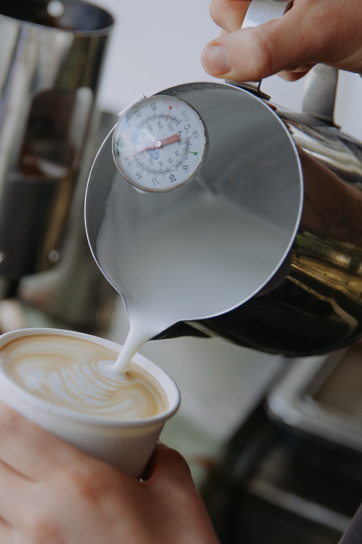 Steamed milk being poured into a latte